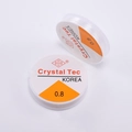 Macro shot of two rolls of Crystal Tec 0.8mm transparent elastic cord for jewelry DIY - 0.8mm