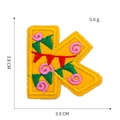 Detail of yellow letter K embroidery patch with floral patterns and dimension specs - Letter K