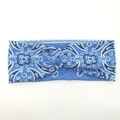 Detailed view of blue paisley knit headband with twist knot design for yoga and sports - Light Blue