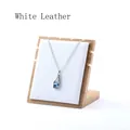 Blue bottle-shaped crystal pendant necklace displayed on a white leather wooden stand - White Leather / Small Non-detachable / White
