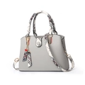 Light grey shoulder bag with red and black checkered straps and heart pendants - Gray