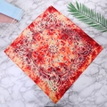 Paisley cotton bandana in vibrant red and orange tie-dye pattern on white marble backdrop - One Size / Red Orange Tie Dye