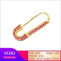 Macro detail of a 27mm brass safety pin pendant with red micro-pave crystals in gold finish - Single Piece / Gold Plated Rose Red Zirconia