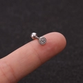 Macro shot of silver helix piercing featuring a round cluster of white cubic zirconia stones - Round Dense Inlay Style (HSPJ1915-3#)