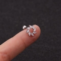 Sparkling zircon flower ear bone stud in silver stainless steel on a fingertip - Flower Cluster Zirconia Stud (HSPJ1915-10#)