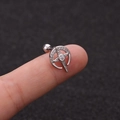 Macro shot of silver crescent moon and star ear stud with zircons on a fingertip - Moon Wrapped Star Zirconia Style (HSPJ1915-16#)
