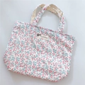 Detail of floral cotton tote bag showing pink flower pattern and woven label text - White Base with Pink Floral Style