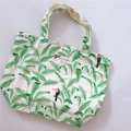 Detail of canvas handbag featuring tropical green leaf and toucan bird prints - Green Leaves & Black Bird Style