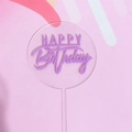 Close-up of clear acrylic Happy Birthday cake topper with purple text on pink background - Acrylic / Purple