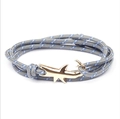 Detail of shark-shaped golden clasp with grey blue-spotted woven rope bracelet - GSY-01 Grey with Blue Dots Rope + Gold Shark Hook