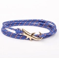 Detail of blue braided nautical wrap bracelet featuring a golden shark anchor clasp - GSY-08 Blue Dotted Rope + Gold Shark Hook