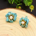 Floral stud earrings with blue turquoise petals and white pearl center on gold metal base - Turquoise