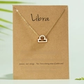 Golden Libra zodiac sign necklace featuring rhinestones on a kraft paper gift card - Libra / Gold