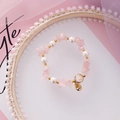 Detail showing irregular pink crystal beads and pearls with gold accents on lace - Pink