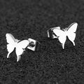 Minimalist stainless steel butterfly stud earrings with polished finish on black background - Silver