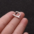 Close-up of hand holding silver micro-pave zircon hoop earring with sleek hinged design - Straight Bar Pave Style (10#)
