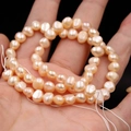 Champagne baroque freshwater pearl strand for DIY jewelry making in a natural luster - 6-7mm Two-sided Light Horizontal Hole High Luster / Natural Orange Pink