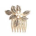 Vintage gold leaf hair comb with elegant white pearls on a minimalist white background - Leaf