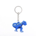 Close-up of blue cartoon dinosaur keychain made of soft PVC with durable metal ring - Blue Dinosaur