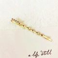 Elegant gold-plated twist hair clip featuring five sparkling rhinestones on a white card - Five Zirconia Twist (3522)