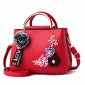 Red PU leather handbag for women featuring 3D floral accents and golden ring handles - Red