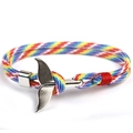 Close-up of rainbow braided paracord bracelet with a silver whale tail metal buckle clasp - Whale Tail - Rainbow