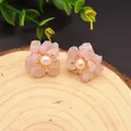 Pink flower stud earrings with white pearl and gold finish on wood background - Rose Quartz