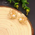 Elegant flower-shaped earrings with amber petals, white pearl center and gold finish - Citrine