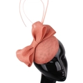 Detail view of salmon pink mesh fascinator with large bow and elegant feather accents - Deep Pink