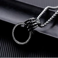 Detail of gothic silver-tone claw pendant holding a textured ring on a thick metal chain - Hand Grabbing Ring