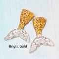 Detail of two resin mermaid tails in bright gold and transparent silver glitter - Bright Gold