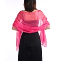 Detail view of the bright pink sheer wedding shawl fabric texture on a model from the back - Rose Red