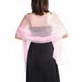 Detail of soft pink sheer tulle shawl draped elegantly over shoulders for wedding guest - Light Pink