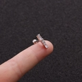 Macro shot of silver barbell earring with three vertical baguette-cut zircons on fingertip - 2# (White Rectangular) / Silver