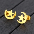 Elegant gold moon and star stud earrings displayed on a dark wood background texture - Gold