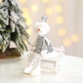 Christmas snowman figurine with silver sequins on white wooden bench with tree background - Silver Snowman