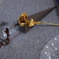 Detail showing 24K gold foil rose inside elegant gift box with decorative ribbon - PVC Triangle Gift Box / Gold / PVC Packaging