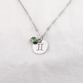 Macro shot of silver stainless steel zodiac necklace with green gemstone and roman numeral II - Gemini Green Gemstone (Shades 3-8)