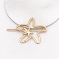 Elegante gouden zeester haarklem met een minimalistisch hol dubbel sterontwerp - Zeester