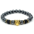 Detailed shot of beaded bracelet featuring gold leopard head and black volcanic stone beads - Leopard Head / Antique Gold