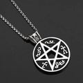 Macro shot of a pentagram hip hop pendant with symbolic textures on a black surface - Pentagram Circle