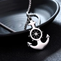 Macro shot of silver anchor and helm pendant with central stone on a metal chain - Ship Anchor Helm