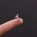 Macro detail of wave-shaped stainless steel stud with tiny zircons held on a fingertip - 3# (S-Shape) / Silver