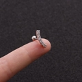 Close-up of curved silver stud with zircons on finger showing tiny size and screw back - 5# (Curved Row) / Silver