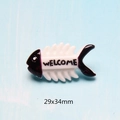 Macro detail of a 29x34mm white resin fishbone accessory with Welcome text and purple accents - Black Fish Bone / 29x34mm