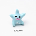 Close-up of 20x22mm blue starfish resin charm with cute cartoon face for DIY crafts - Smiling Starfish