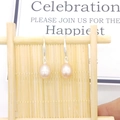 Macro view of teardrop freshwater pearl earrings with S925 sterling silver hooks - Standard Hook / Pink