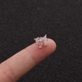 Macro view of tiny rose gold bow stud earring with zircons held on a fingertip - Rose Gold Pave Bowknot Style (Rose Gold 6#)