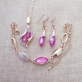 Detail of rose gold jewelry set with pink stones and sparkling crystal accents - Gold Rose Red