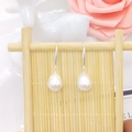 Detail of drop-shaped freshwater pearl earrings on S925 silver hooks with floral decor - Standard Hook / White